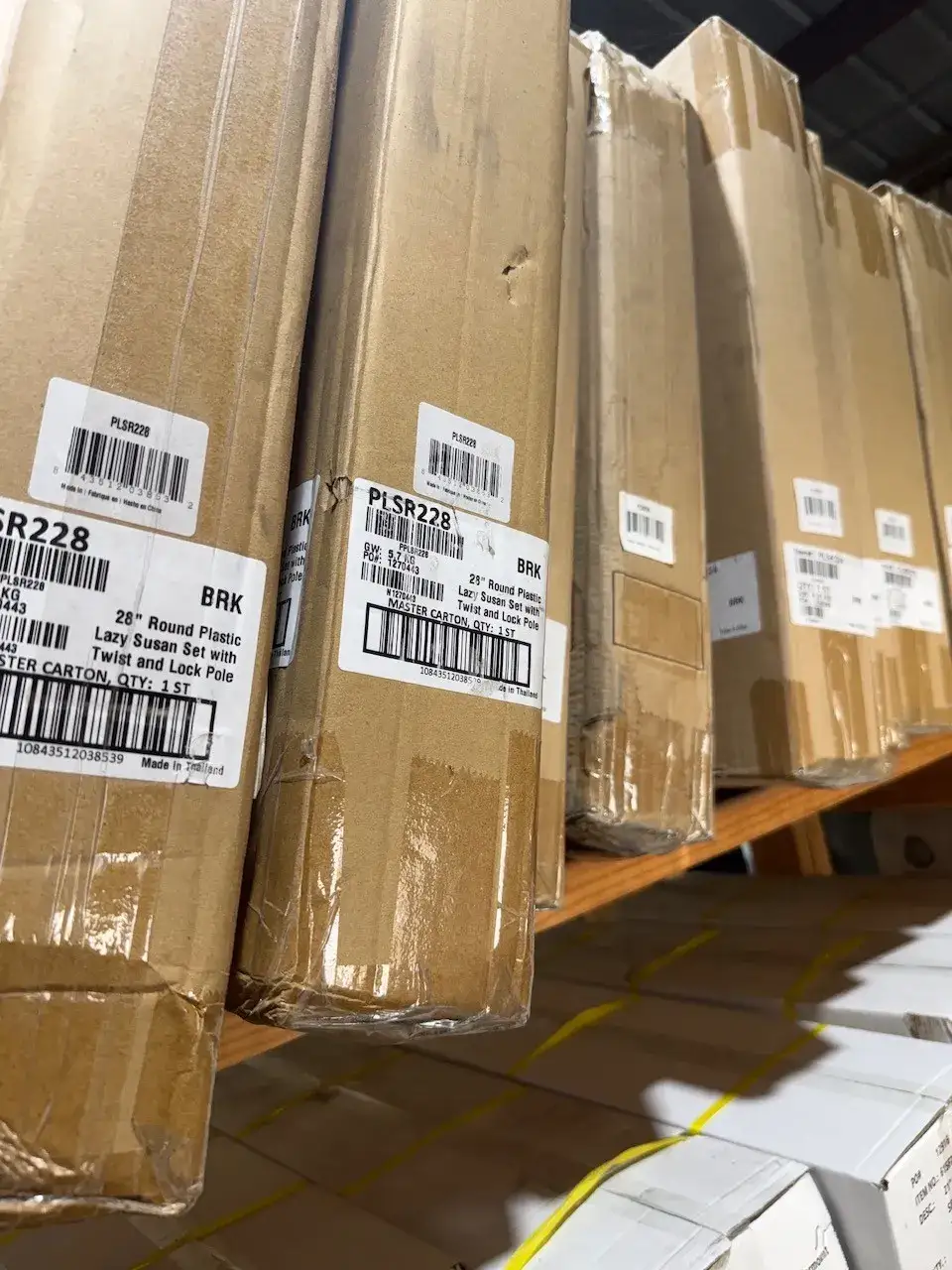 Boxed lazy Susan sets and cabinet accessories stocked on warehouse shelves at Trinity Doors in Vidor, TX