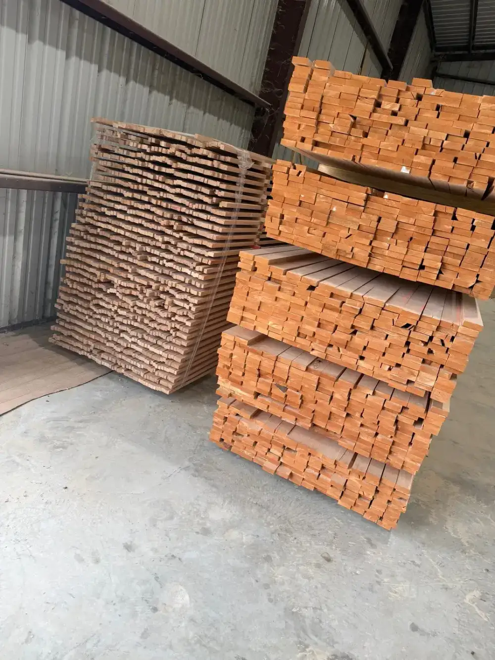 Stacks of S4S hardwood lumber stickered and stored inside the Trinity Doors warehouse in Vidor, TX