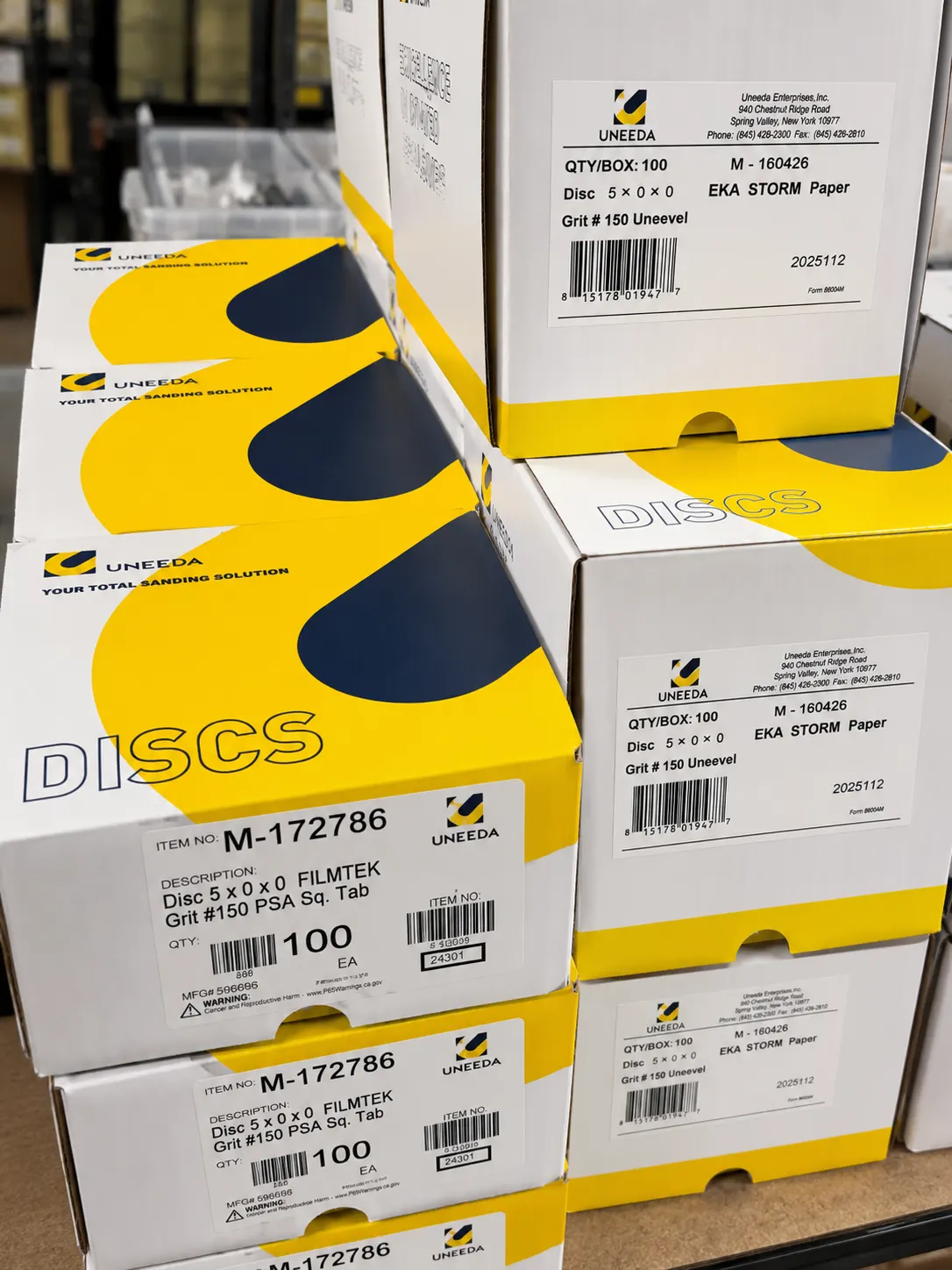 Boxes of sanding discs stocked on the supply shelves at Trinity Doors in Vidor, TX
